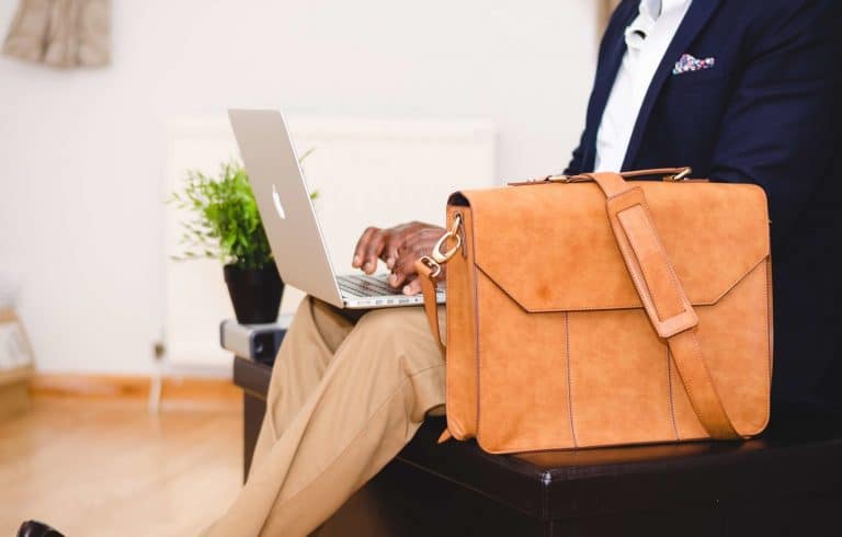 Man at laptop with briefcase
