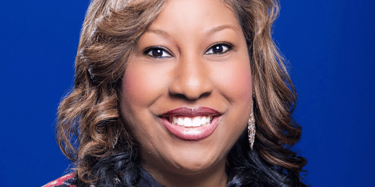 Headshot of recruiter Tangie Pettis smiling against a blue background