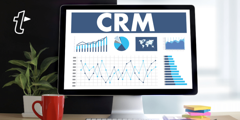 a desktop computer showing graphs and 'CRM'