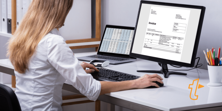 A woman sat at a desk creating an invoice