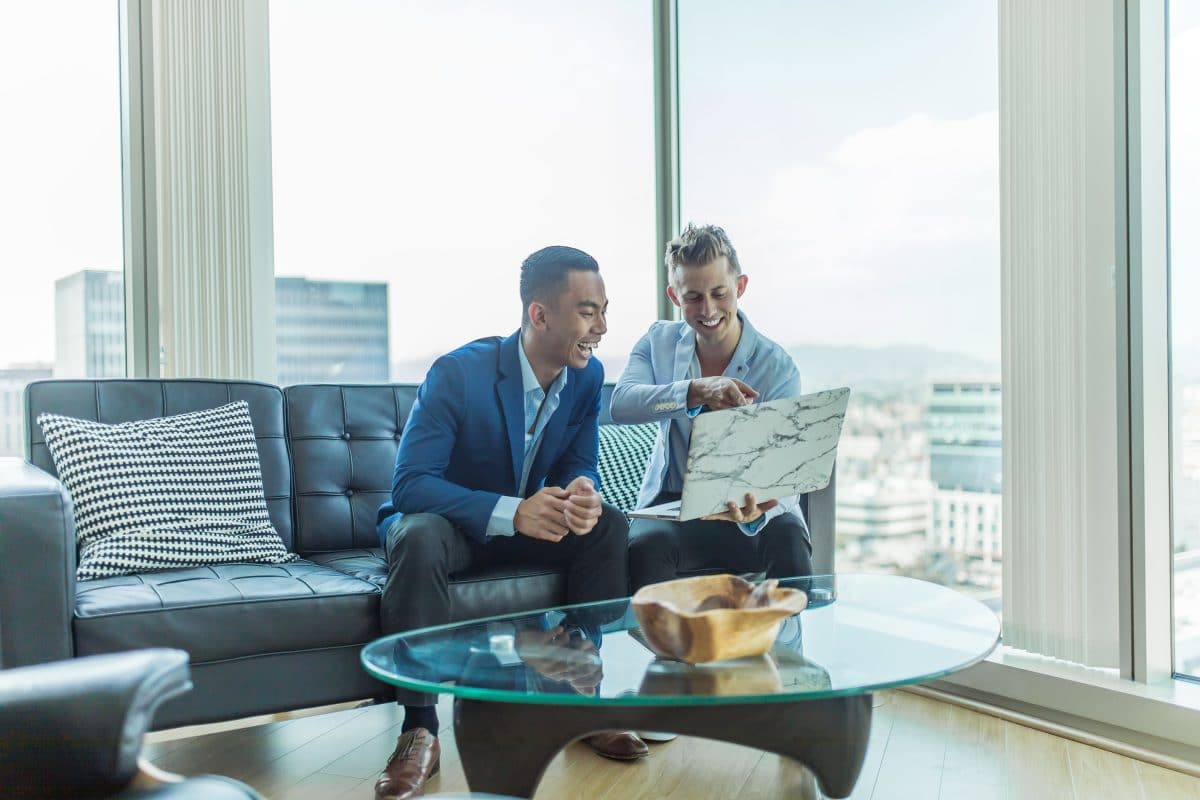 two men in an office grinning