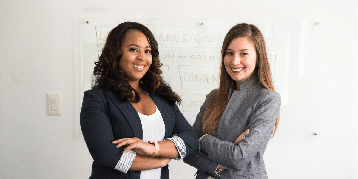 two woman side by side smiling