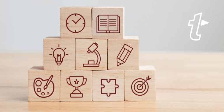 Stacked wooden blocks with icons for time, learning, ideas, research, writing, creativity, achievement, problem solving and goals