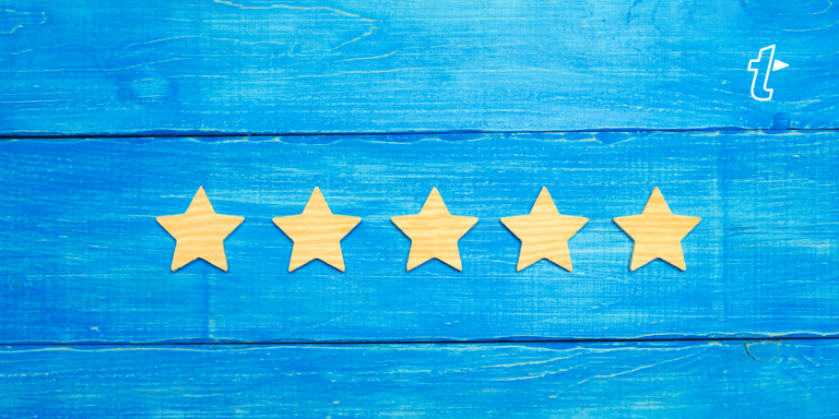 Five wooden stars in a row on a blue wooden background, representing a top rating