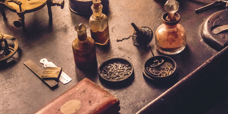 Vintage watchmaker's workbench with bottles, tools and small parts, representing the components of a strategy