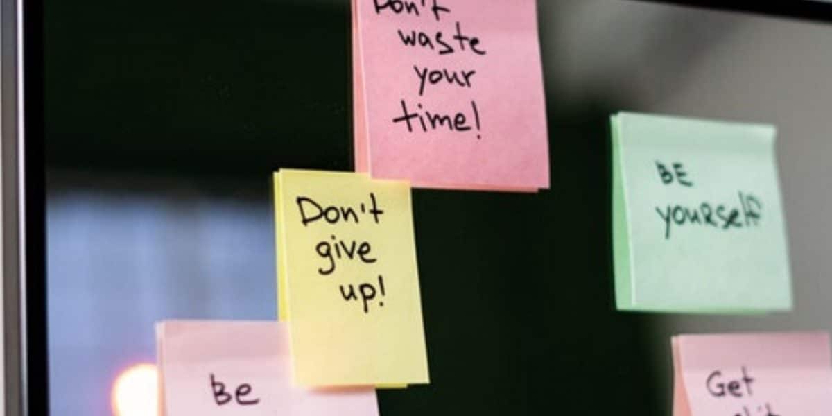 Post-it notes with motivational messages stuck on a wall