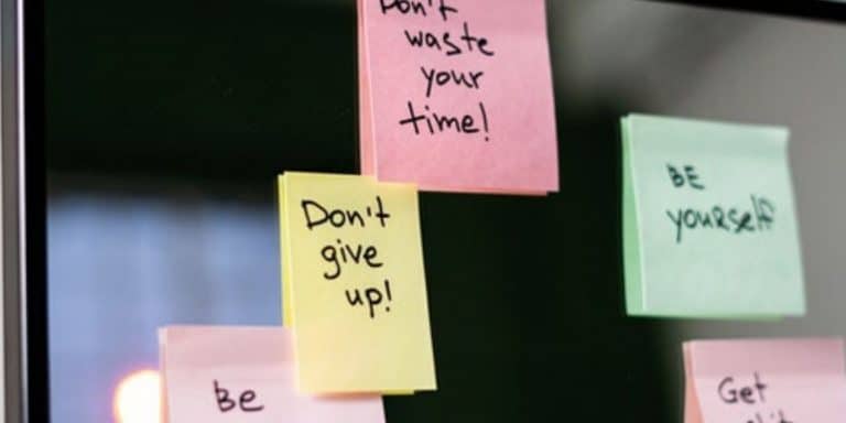 Post-it notes with motivational messages stuck on a wall