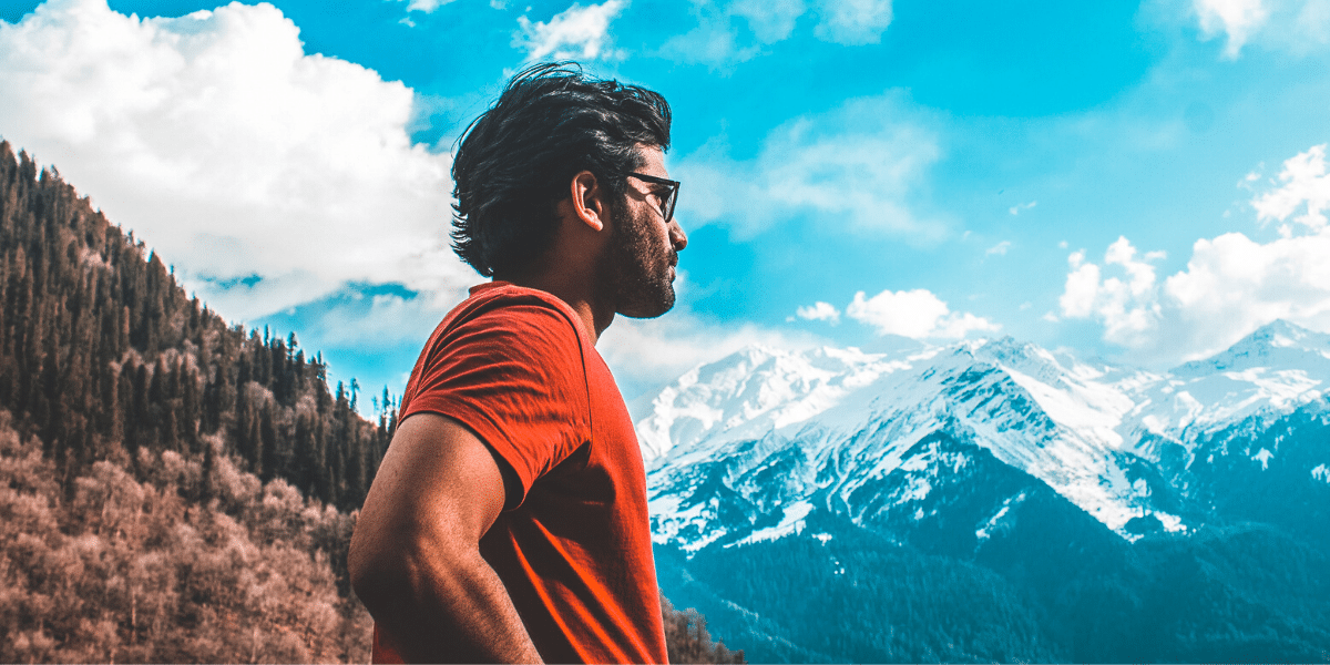 Man standing looking at beautiful mountain view