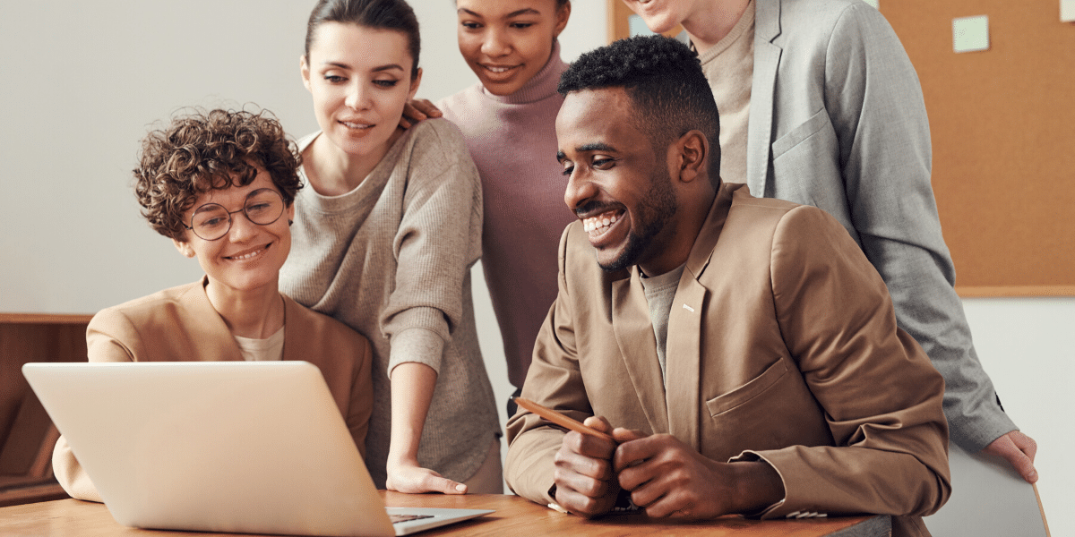 A diverse group of coworkers looking at a computer