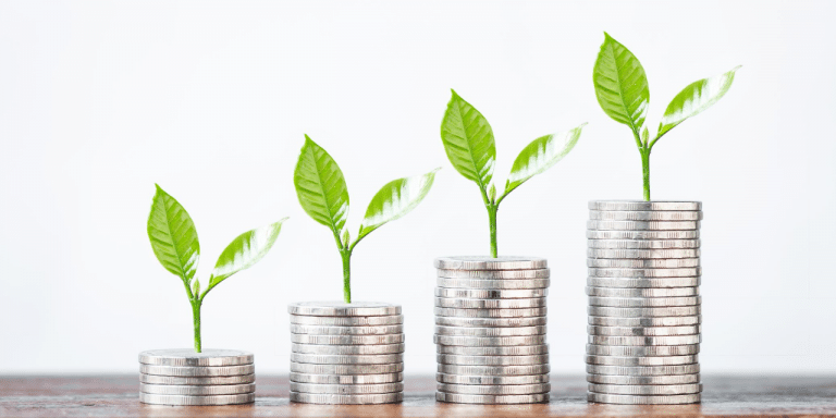 small plant buds growing from stacks of coins