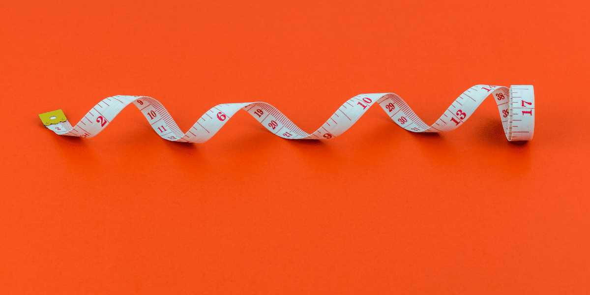 measuring tape on red background