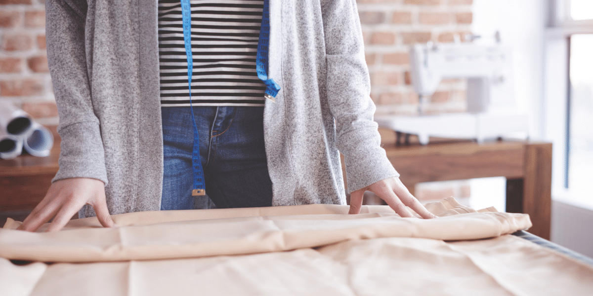 woman with measuring tape and fabric