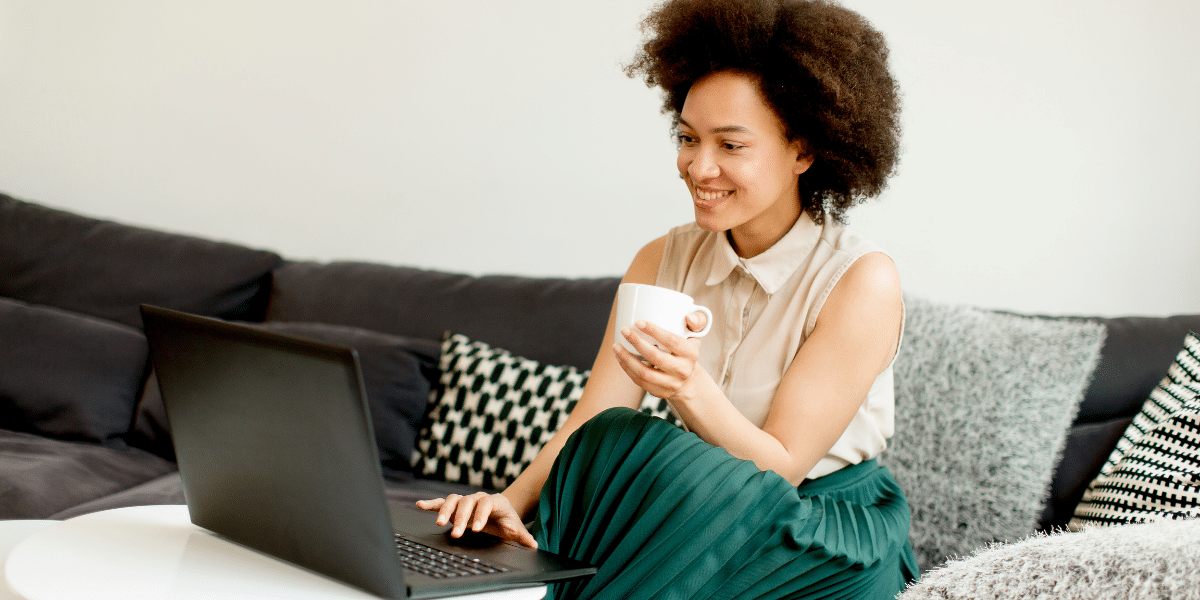 woman smiling drinking from a mug