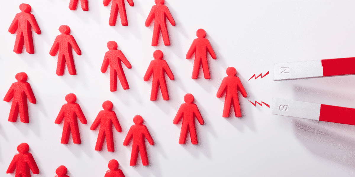people shaped figures being attracted to a magnet