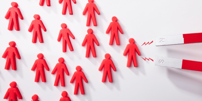 people shaped figures being attracted to a magnet
