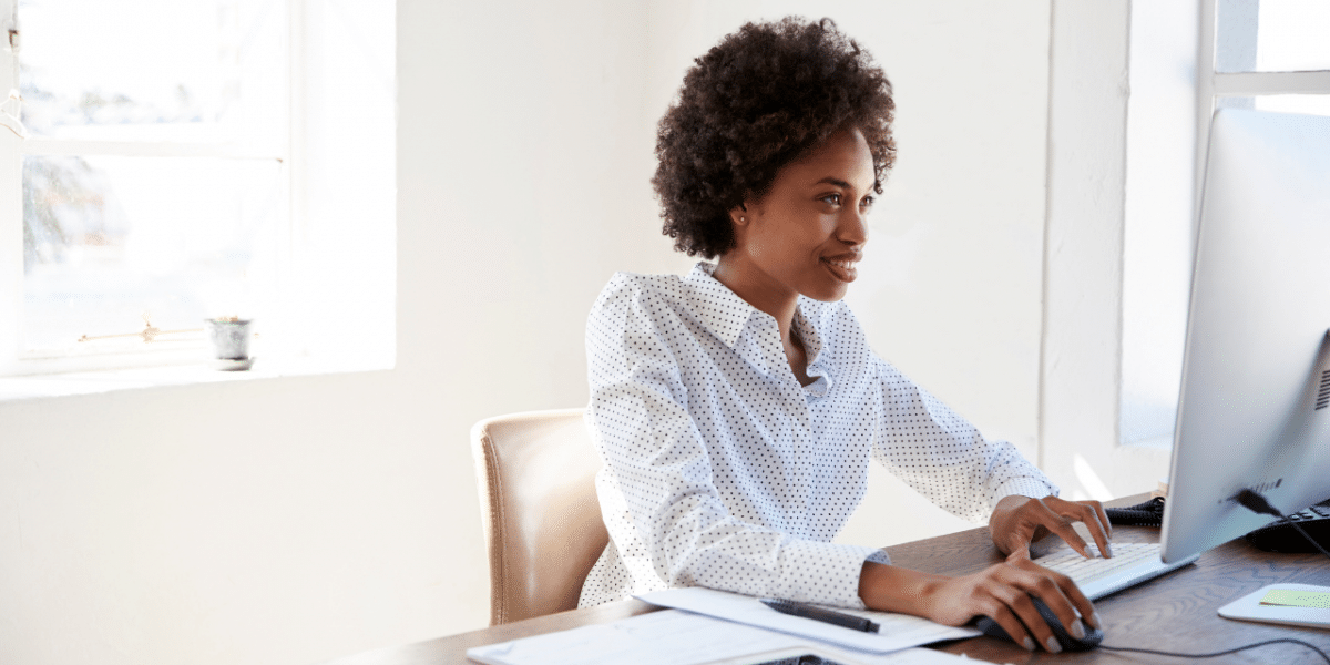 woman sat at desk typing