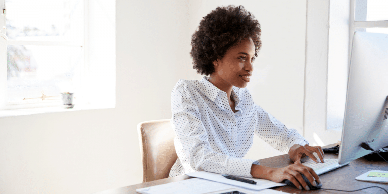 woman sat at desk typing