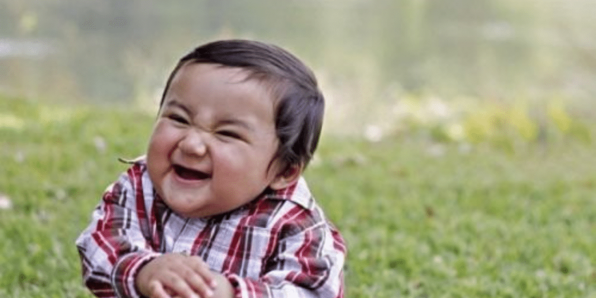 Smirking toddler in a plaid shirt, known as the Evil Kid meme, for a post on customer service memes