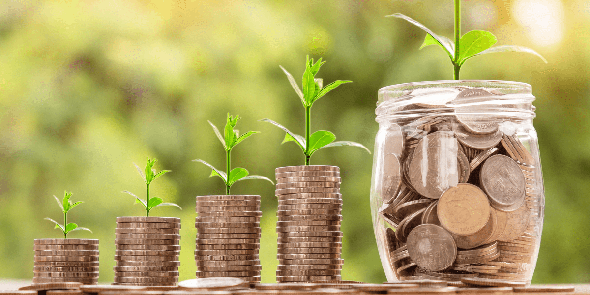 growing stacks of coins with plants growing from the top