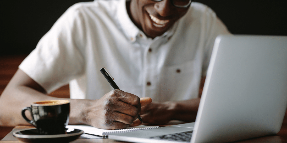 man writing by hand