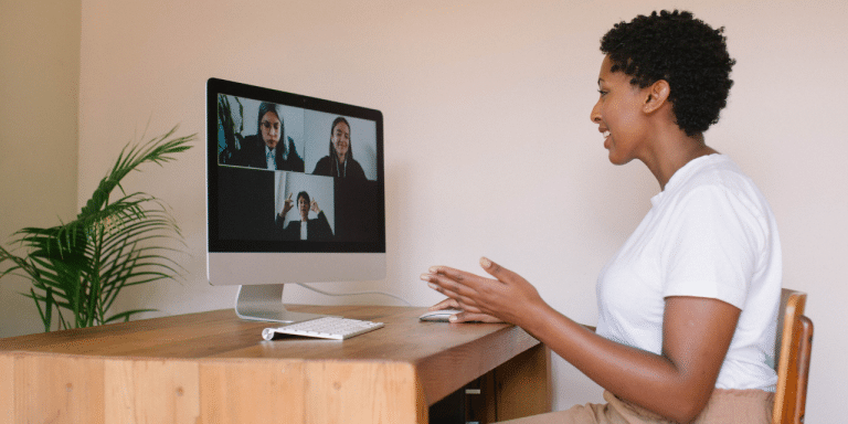 female sat at desk in remote meeting