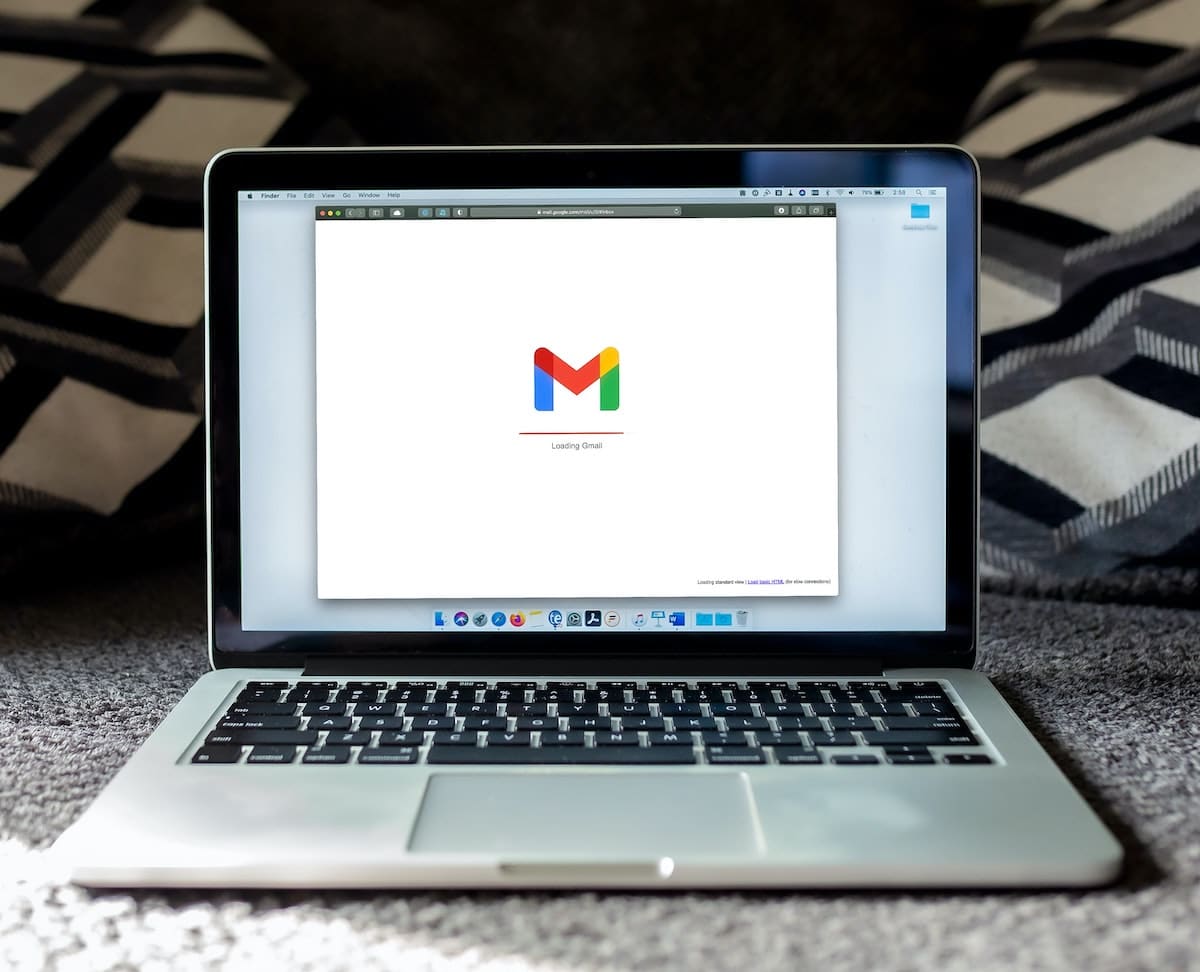 Laptop on a carpet loading Gmail