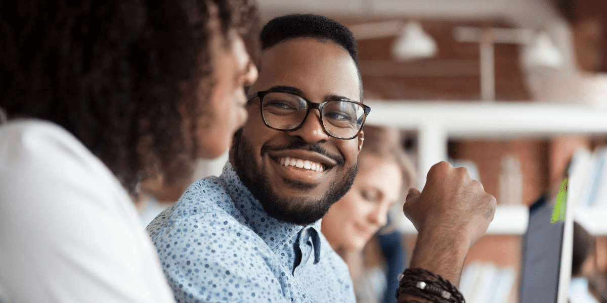 man smiling at colleague