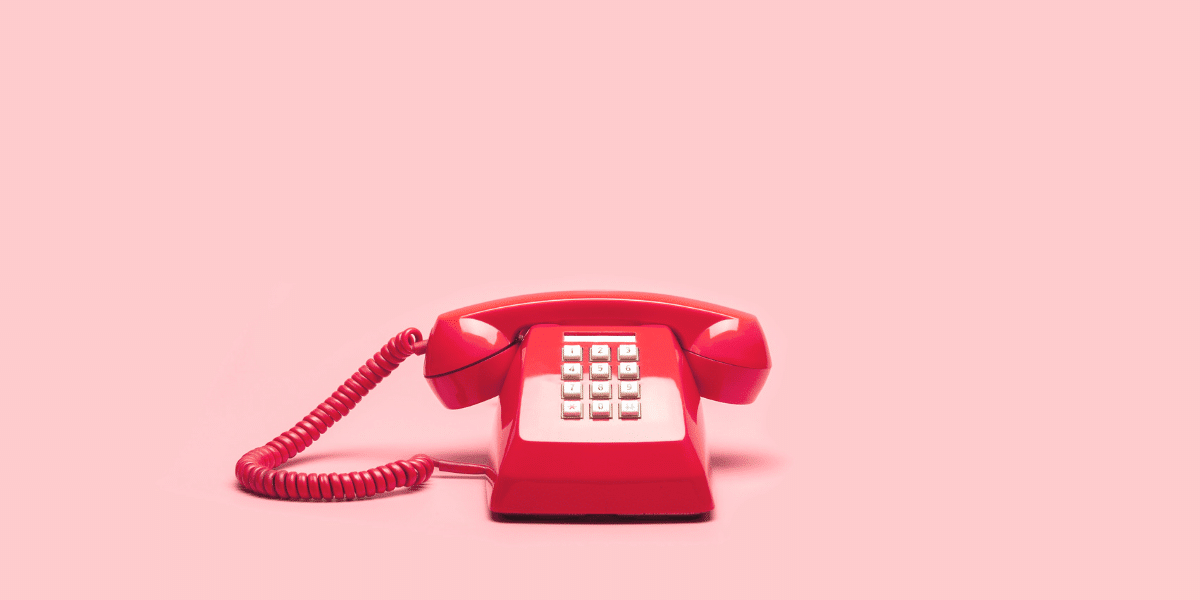 red telephone on pink background