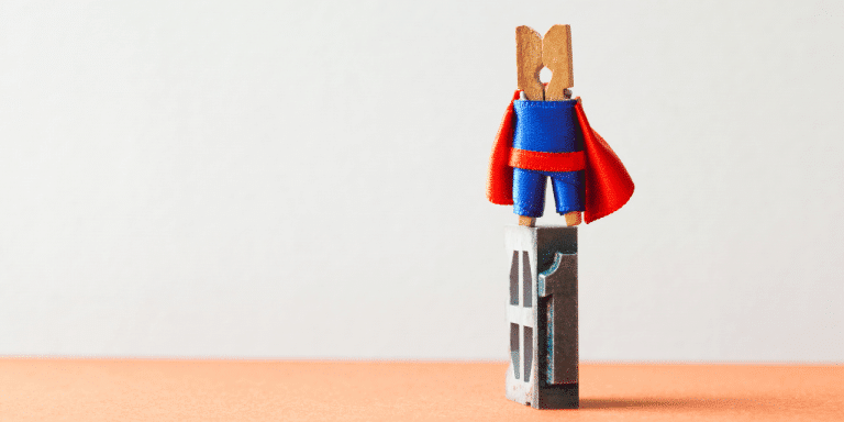 small peg wearing a super hero costume