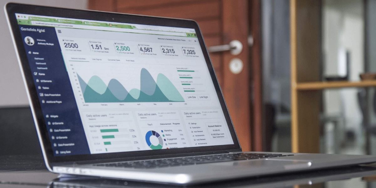 A laptop with several different graphs showing growth