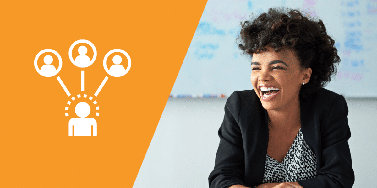 A laughing woman wearing a blazer, with a busy whiteboard behind her in a meeting or office setting. Half of the picture is split with a bright orange colour and an organogram of people over the top in white.