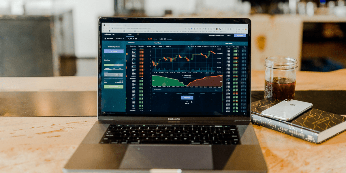 A laptop with graphs showing revenue rising