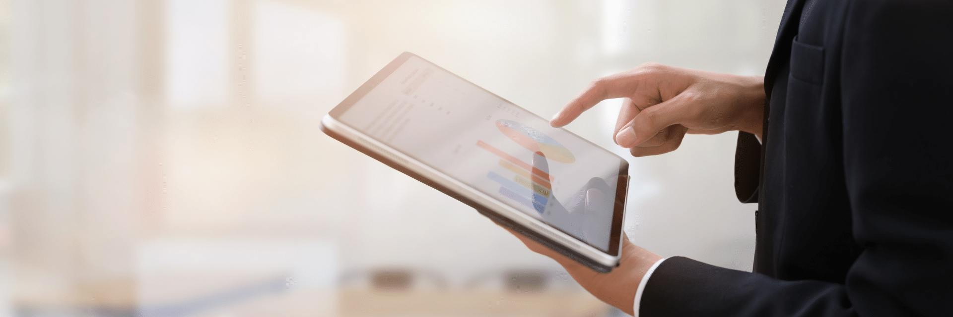 The view of someone's arms holding a tablet, tapping the screen