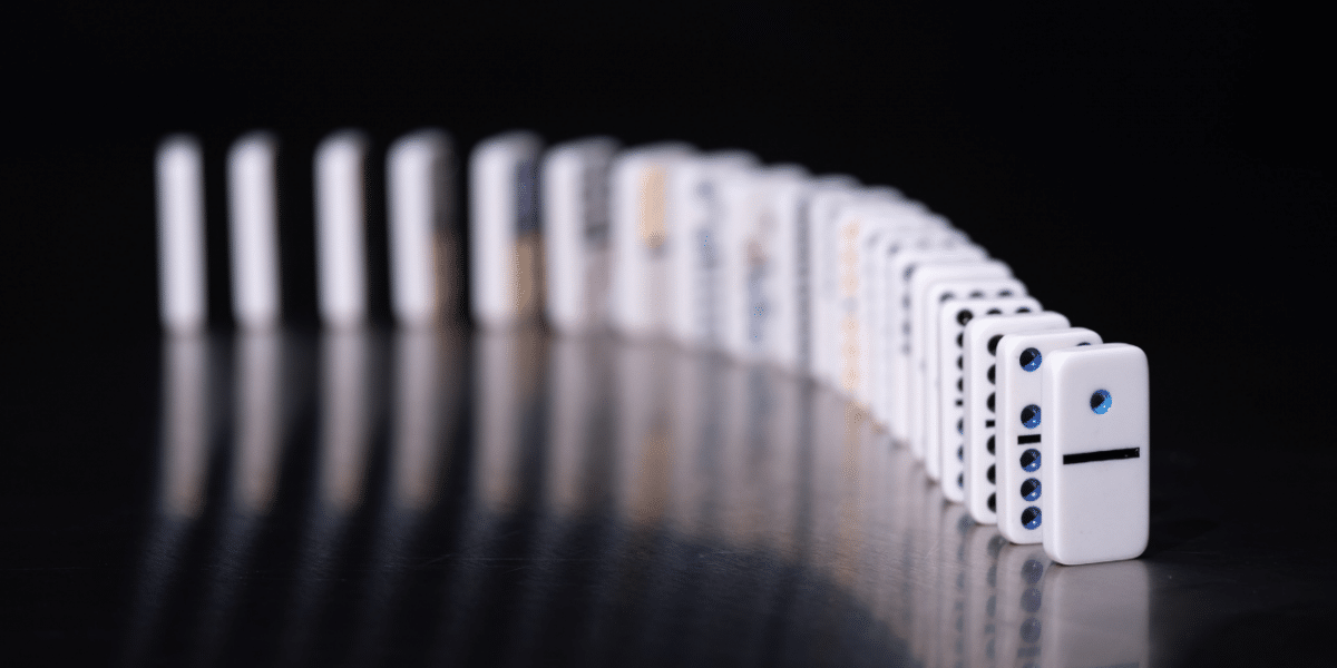 A line of dominos against a black background