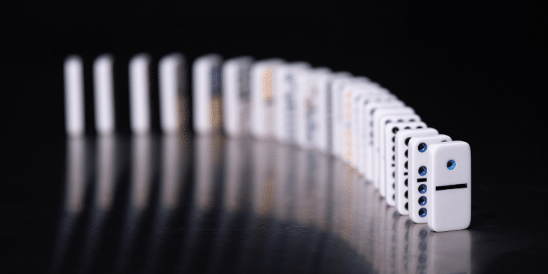 A line of dominos against a black background