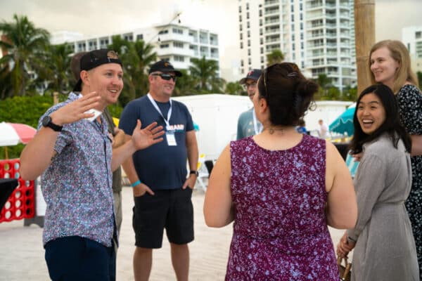 TextExpander employees gather in a circle on the beach during the TextExpander Miami Retreat.