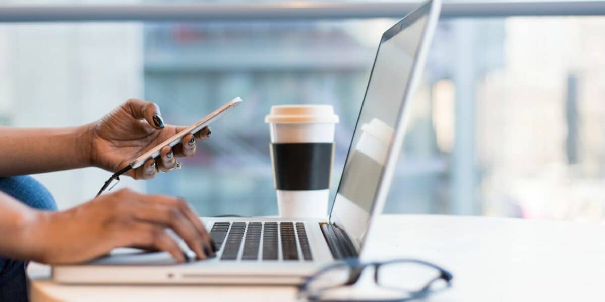 Person on smartphone and Macbook