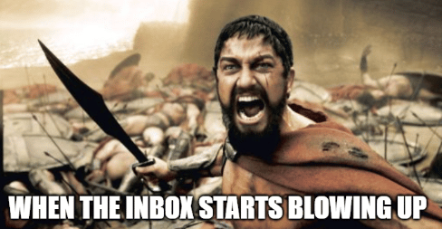 King Leonidas standing defiant holding a spear. Text: "When the inbox starts blowing up."