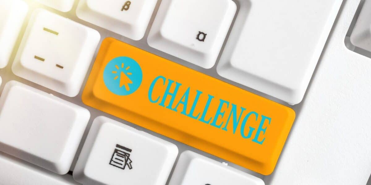 Orange keyboard key labelled "Challenge" with a cursor icon, introducing the AutoIt vs AutoHotkey comparison
