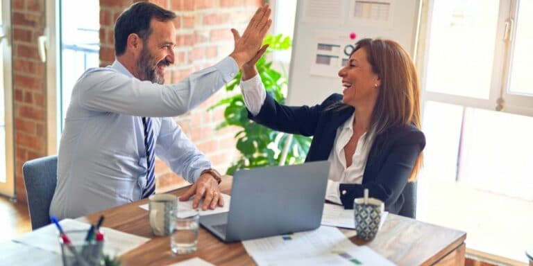 Male boss high-fives his team of one
