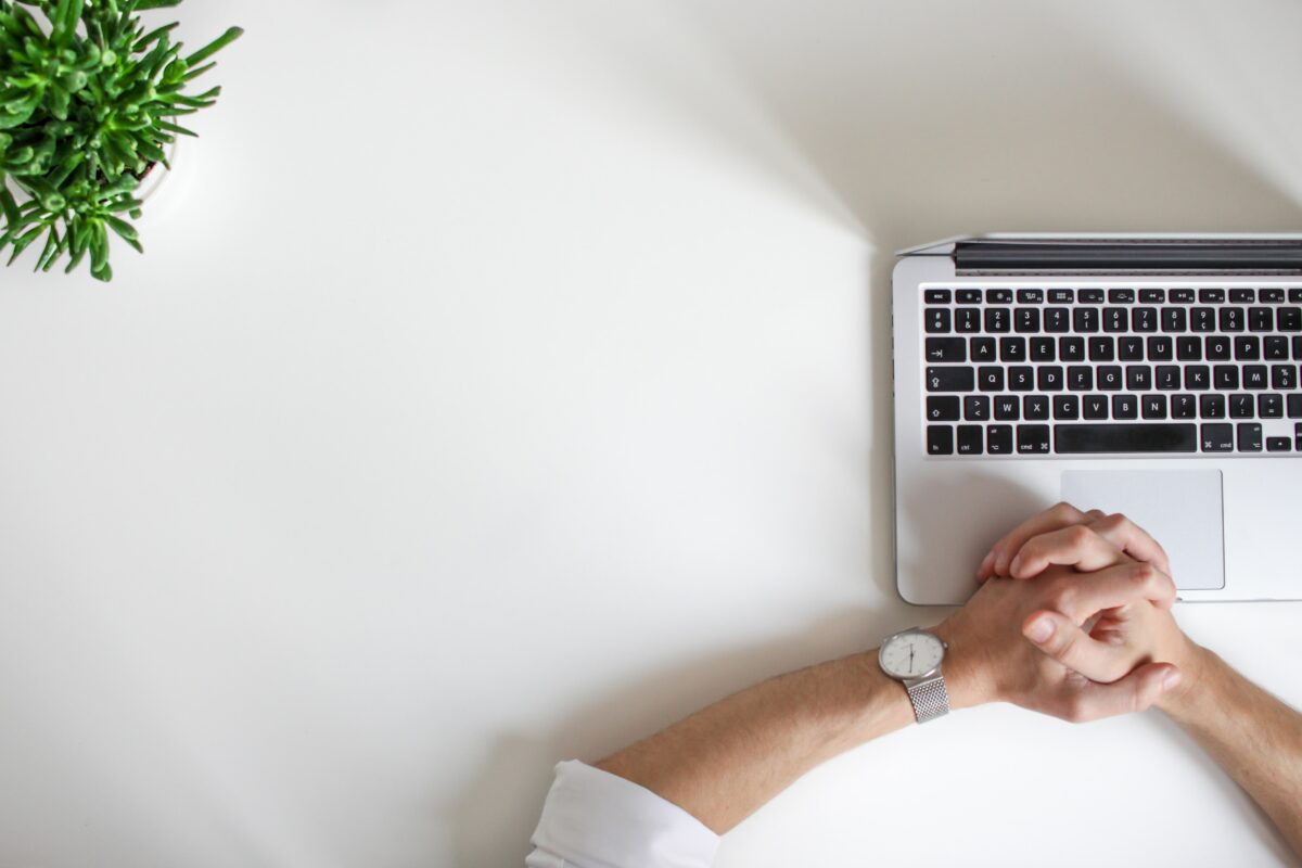 Therapist sits with laptop open ready to write therapy progress notes.