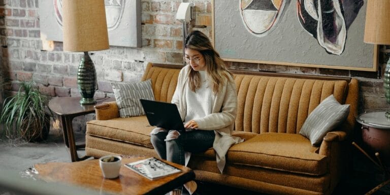 Woman works on remote team communication on her laptop