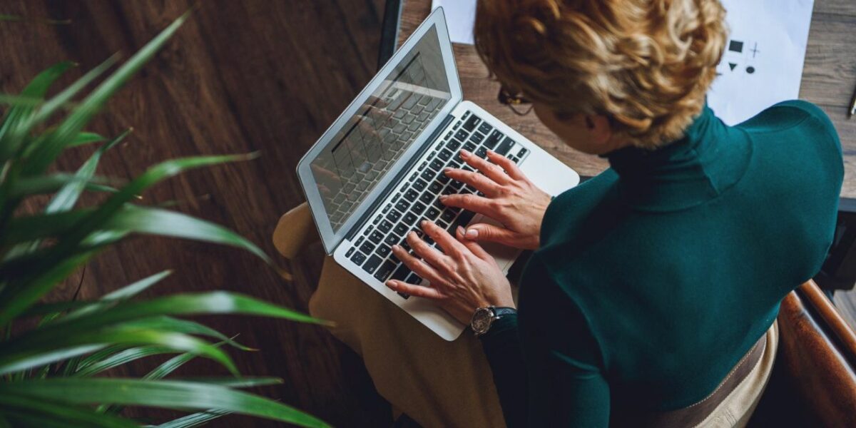 A woman typing on a laptop