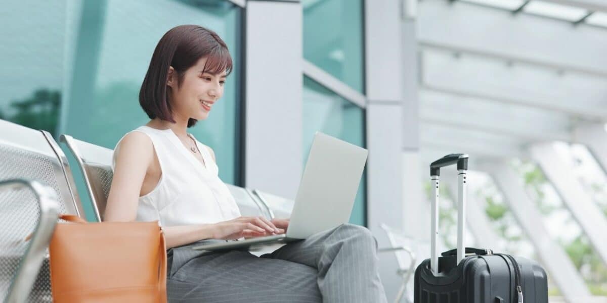 Woman using laptop and ClickUp with TextExpander