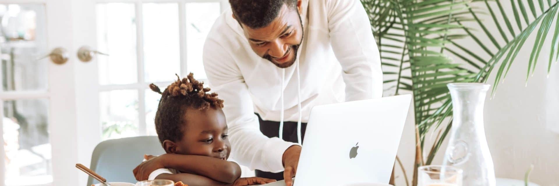 Working parents need to balance parenting and remote work, as shown in this photo of a father and his child